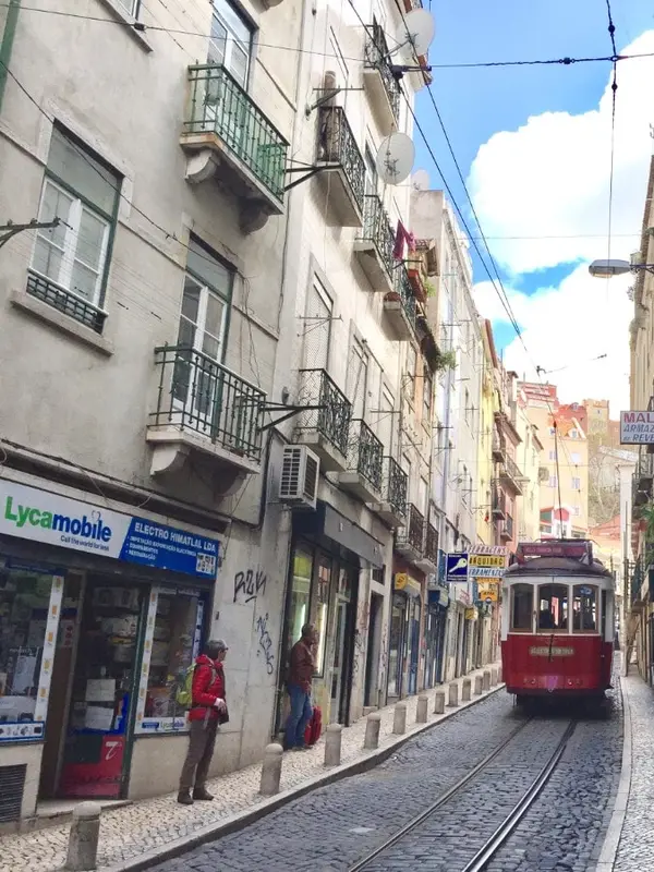 The yellow Tram 28 climbing through Lisbon's Alfama district