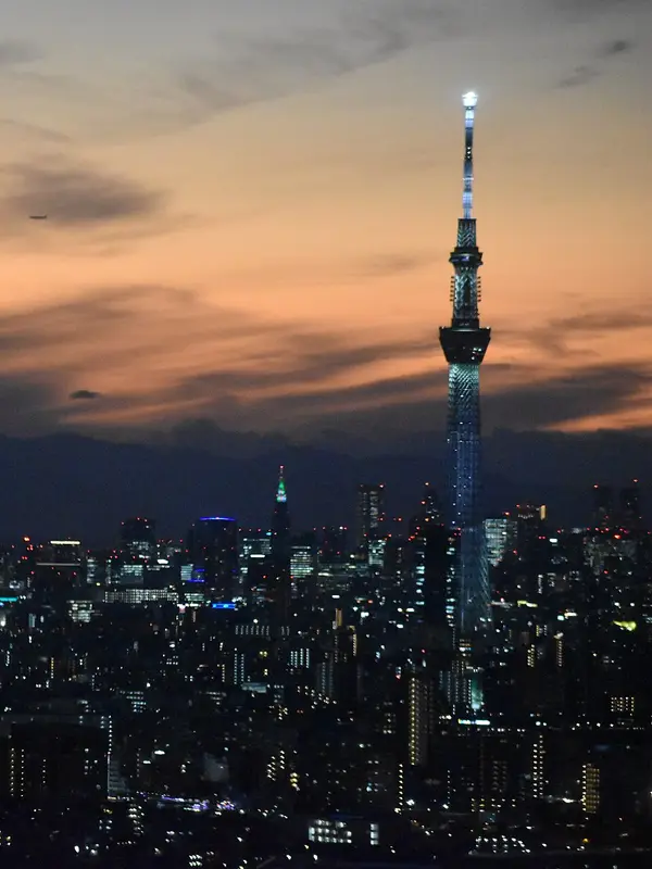 Tokyo Skytree lit at dusk above the city skyline